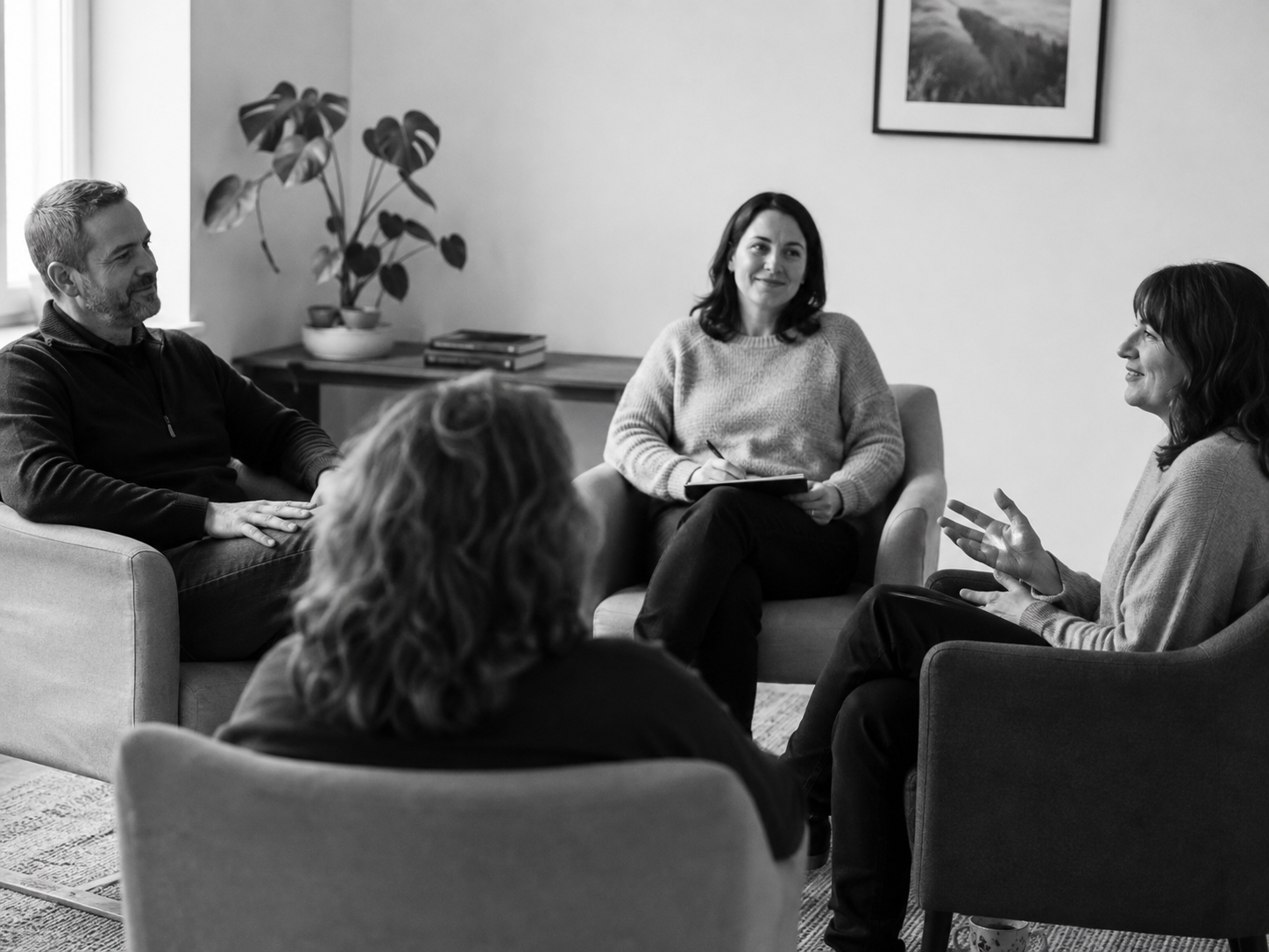Adults reflecting and talking during a small group coaching session